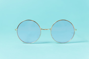 Round Italian sunglasses on white background. Blue eyeglasses. Front view of glasses with rounded...