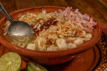 White pozole with lettuce, oregano, onion, grated radish and lemon. Typical Mexican food made from corn, pork, chicken and salt 3.