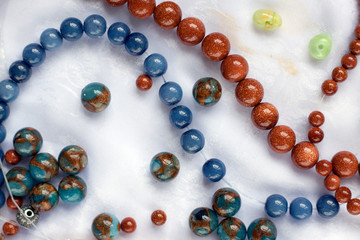 Necklace jewelry stone balls on the table. Handmade modelling process.