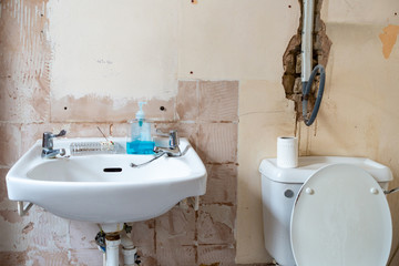 A bathroom stripped bare as it is being refurbished and modernised.