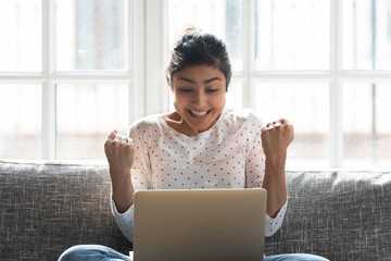 Indian woman in anticipation online lottery result holds fists together hopes for luck