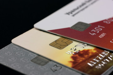 A lot of different bank credit cards with chips on a black background