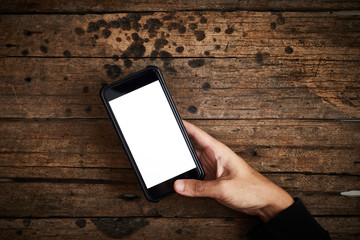 Smartphone white screen on wooden table. .