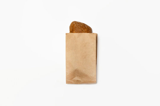 Fresh Black Bread in a brown kraft Paper Bag Mockup on white background.High resolution photo.