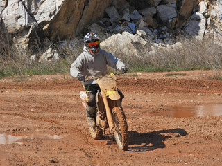 Zoom photo of unidentified motocross rider performing extreme stunts in off road dirt track