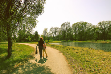 Two girls walking in beautiful spring park