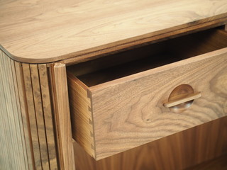 Original designer chest of drawers made of natural wood in its entirety, as well as its details on a white background, from different angles.