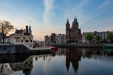 Fototapeta na wymiar Modern dutch architecture and canal. Cityscape in Amsterdam. Tourism in Europe.