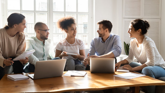 African female group leader shares creative thoughts with diverse teammates