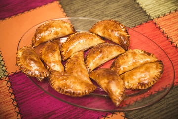 glass dish with homemade baked Spanish stuffed Empanadas