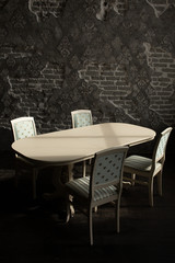 A set of furniture for the kitchen in the loft interior. A collection of chairs and tables for dinner in the family circle.