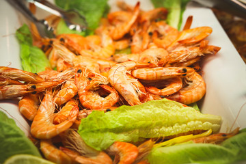 fresh boiled shrimp on lettuce leaves ready to eat