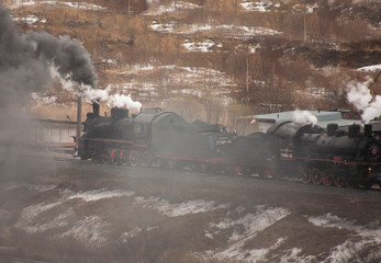 Steam engine locomotive on rails