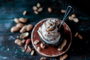 Ice cream with peanuts on a dark background. Summer dessert with nuts.