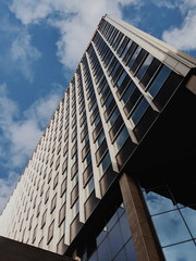 Large office building from low angle with blue sky Liverpool leading lines