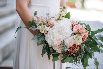 Brides wedding bouquet in women's hands. wedding flowers