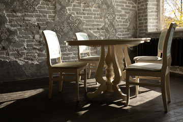 A set of furniture for the kitchen in the loft interior. A collection of chairs and tables for dinner in the family circle.