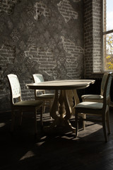 A set of furniture for the kitchen in the loft interior. A collection of chairs and tables for dinner in the family circle.