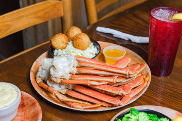 crab legs with hushpuppies and coleslaw