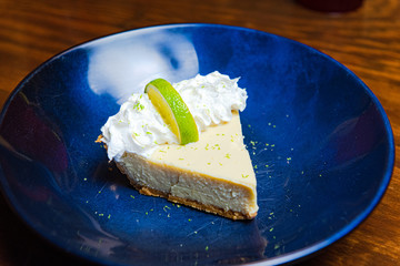 key lime pie slice in blue bowl