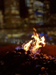 Flickering fire at night with blurry city background Chicago 