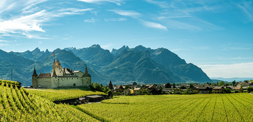Panoramic view on city of Aigle with beautiful castle and Alps in background