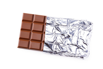 milk chocolate bar in foil isolated on white background. top view