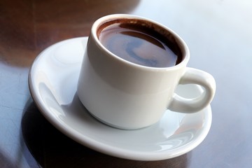 Close-up of Turkish coffee in white ceramic cup