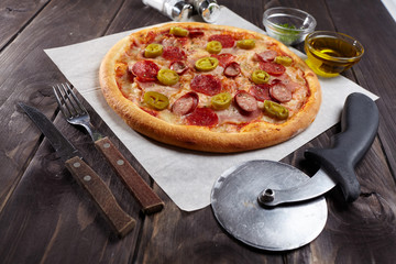tasty pizza on the wooden background