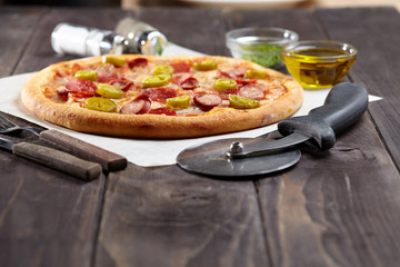 tasty pizza on the wooden background