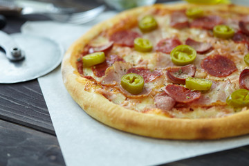 tasty pizza on the wooden background