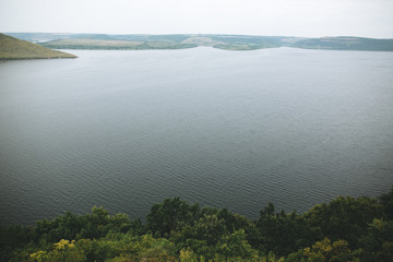 Beautiful view on big lake among hills. River and cliffs landscape. Bakota lake and Dnister river in Ukraine. Travelling and exploring national park. Camping on summer vacation