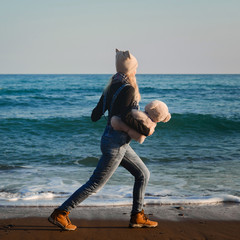 Girl on the beach plays with a teddy bear