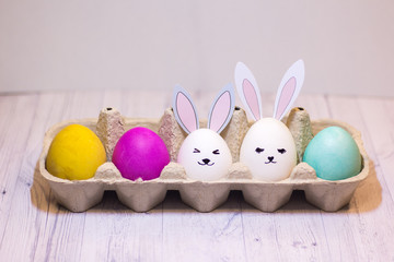 Easter eggs and cute rabbits in a cardboard box. happy Easter. concept.