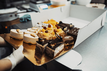 Professional confectioner working making and decorating delicious sweets. .