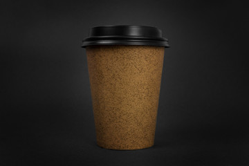 Coffee to go cup on black background.