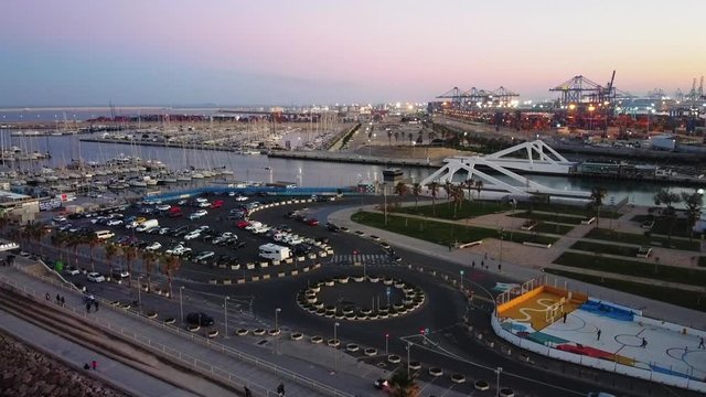 Aerial view of the PORT of Valencia at sunset with boats and yachts in the background. Vista a&eacute;rea de El puerto de valencia al atardecer con barcos y yates al fondo.