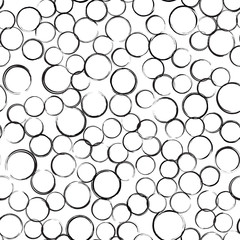 Abstract grunge bubbles seamless pattern. Black circles of different sizes on white background. Wrapping texture with randomly placed round imprints. Vector eps8 illustration.