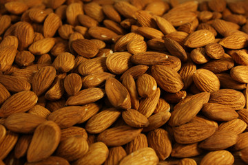 Pile of delicious and healthy raw almonds covering the entire photo.