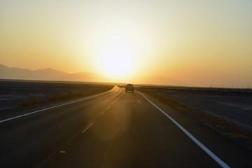 Naklejka premium driving on highway at sunset
