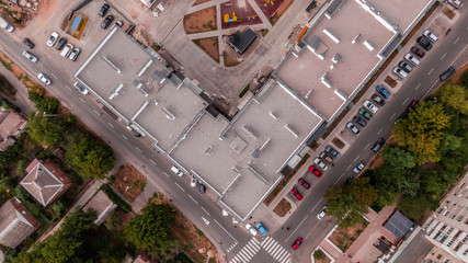 vertical aerial view over car parking place near the multi-storey building