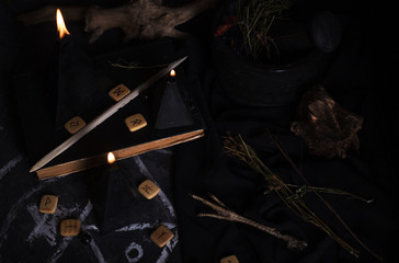 Black magic ritual with candles and runes