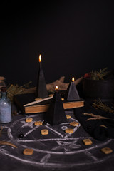 Black magic ritual with candles and runes