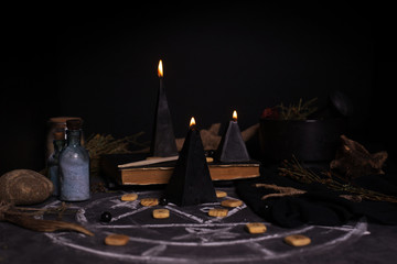 Black magic ritual with candles and runes