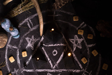Black magic ritual with candles and runes
