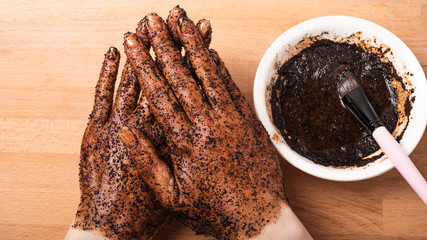 Close-up coffee scrub on female hands
