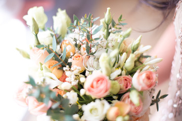 wedding rings on bride’s bouquet