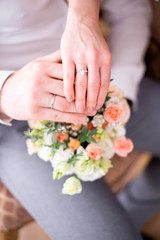 hands of the bride and groom at the wedding, wedding rings, bouquet, dress, couple, family