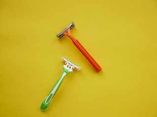 Two unisex razors on the yellow background