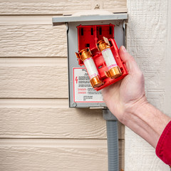 Man checks the two fuses to see of they will work